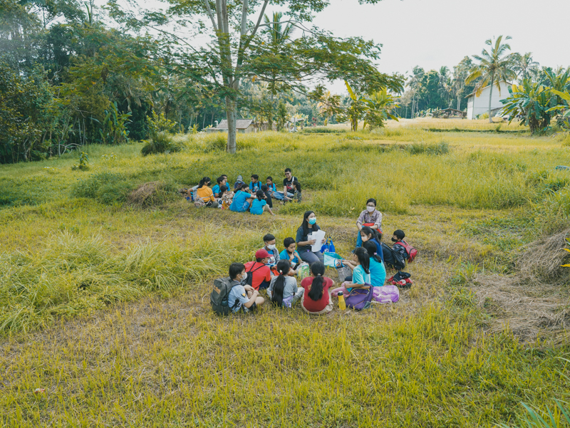 Field Trip - Eco Warriors have a discussion with Facilitators around the rice fields