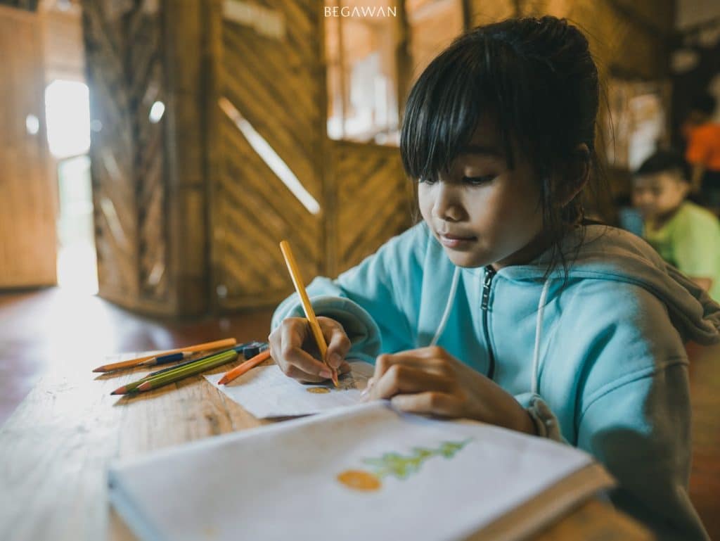 An Eco Warrior Student drawing an illustration for ‘Entik-Entikan Bali’ book project.